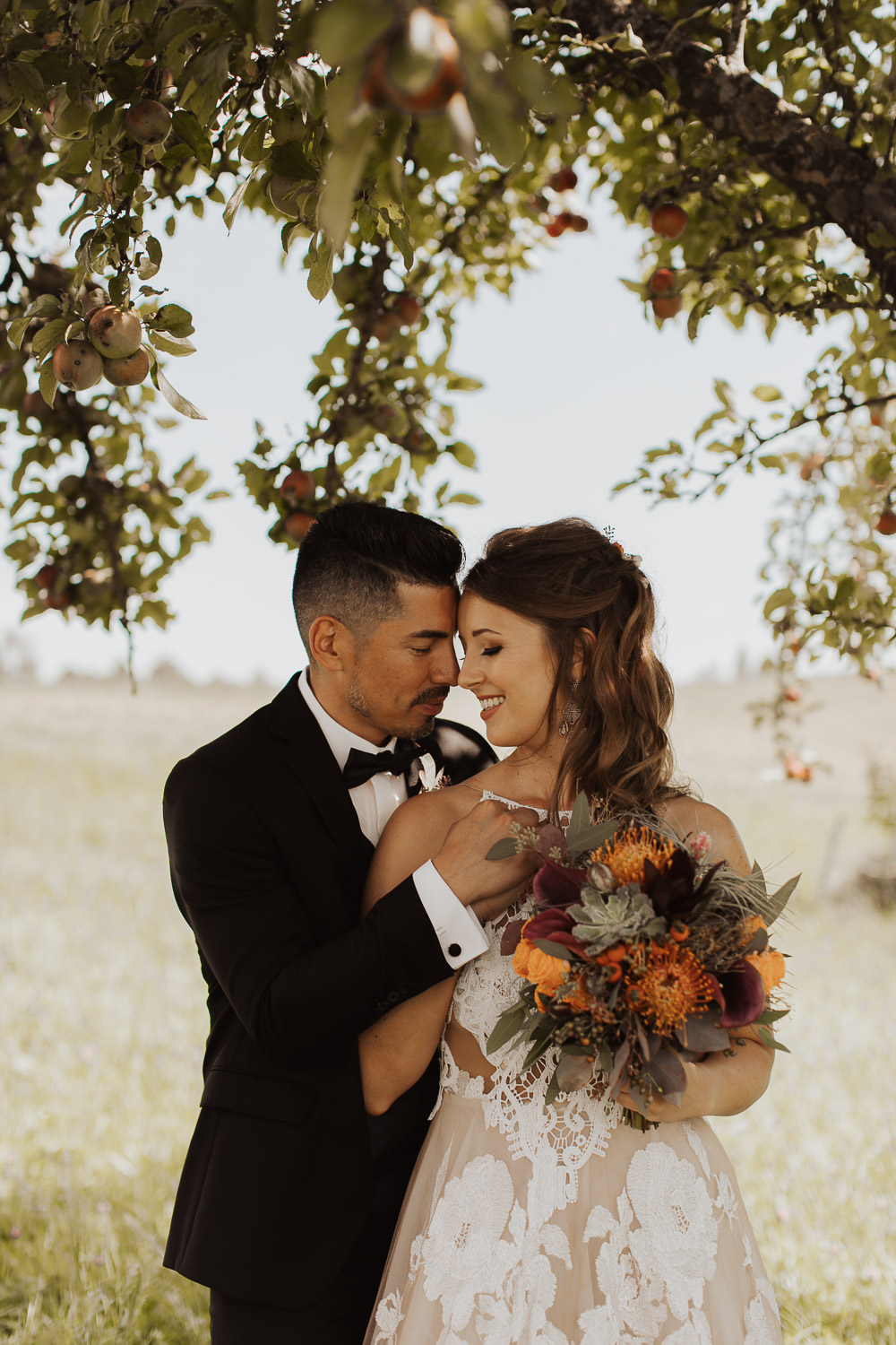 boho inspired wedding photo under apple tree